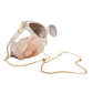 Close-up of sunglasses connected to a gold chain, resting elegantly on raw quartz crystal. The clear frame and gold accents shimmer against the textured background.

