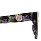 Macro close-up of the sunglasses’ temple arm, spotlighting the engraved gold medallion, smooth acetate finish, and layered moondust colour palette. Design meets craftsmanship in this premium eyewear piece.

