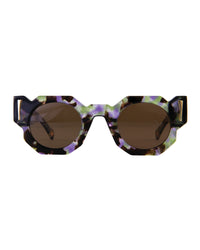 Close-up front view of The Cosmos – Moondust/Amber sunglasses by Fallenbrokenstreet. Features a cosmic acetate frame with soft galactic tones and amber CAT3 lenses. Highlighting the unique octagonal shape and polished gold details on temples. Clean white background for Shopify listing.

