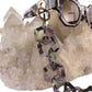 Macro image showing the Moondust SUPERNATURAL Chain by Fallenbrokenstreet attached to sunglasses resting on a quartz crystal. Emphasis on the gold-plated hardware, acetate link texture, and cosmic colour shifts. Great for showcasing product quality and detailing in an editorial or e-commerce context.


