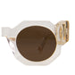 Studio image displaying the rounded amber lenses and clear temple arms of The Cosmos sunglasses. Close-up on the iconic Fallenbrokenstreet silhouette with gold hardware. Highlights comfort fit and timeless style.

