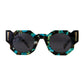 A pair of sunglasses with a patterned acetate frame, polarised lenses, and 24k gold finishings. The sunglasses are displayed in a position where both the front and side views are visible, showcasing the design and style.