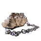 SUPERNATURAL Chain – Moondust styled in a looped fashion around quartz crystal with sunglasses propped on top. A full view of the acetate hex links and their dreamy shifting tones, making this eyewear chain a standout piece. Styled for product showcase, flat lays, or ecommerce storytelling.

