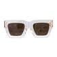 Front view of The Mischief – Skywalker/Amber sunglasses with white acetate frame and warm amber lenses. Set against a soft grey background, showcasing gold accents and bold silhouette.

