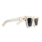 Folded view of The Mischief sunglasses showcasing both sides and arms. White acetate and black lenses highlighted against a soft grey backdrop.

