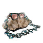 The Mischief sunglasses styled with pink lenses, black acetate chain, and bespoke case, resting on quartz crystals. Chains sold separately.

