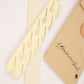 Flat-lay showing two natural felt hat filler strips with branded Fallenbrokenstreet kraft paper tag. Each strip measures 16cm and includes strong adhesive backing for easy placement under the hat lining. A simple and effective solution for hat wearers needing size adjustment or better grip. Presented with clean aesthetic for online store visuals.