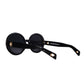 Flat lay of THE ORBIT – Stardust round sunglasses showing polarised black lenses and acetate frame