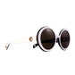 Side angle of THE ORBIT sunglasses showing 24k gold detail and curved white frame arms.

