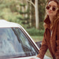 Fashion photo of model in The Cosmos – Skywalker/Amber sunglasses styled with shearling jacket