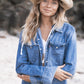 Outdoor lifestyle shot featuring a model in double denim wearing The Lover Straw Hat in Natural. Captures a carefree bohemian mood, with soft light filtering through trees, evoking freedom, sun-drenched days, and Australian summer spirit.

