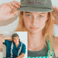 Female model adjusting Dope Lemon dad cap with second model behind her, both wearing relaxed summer outfits.